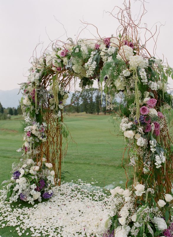 arbor canopy with curly willow branches, baby's breath, blush roses, lavender rosemary, and other greenery 